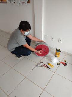 Renan Pereira Biazini preparing the GNSS antenna for installation.